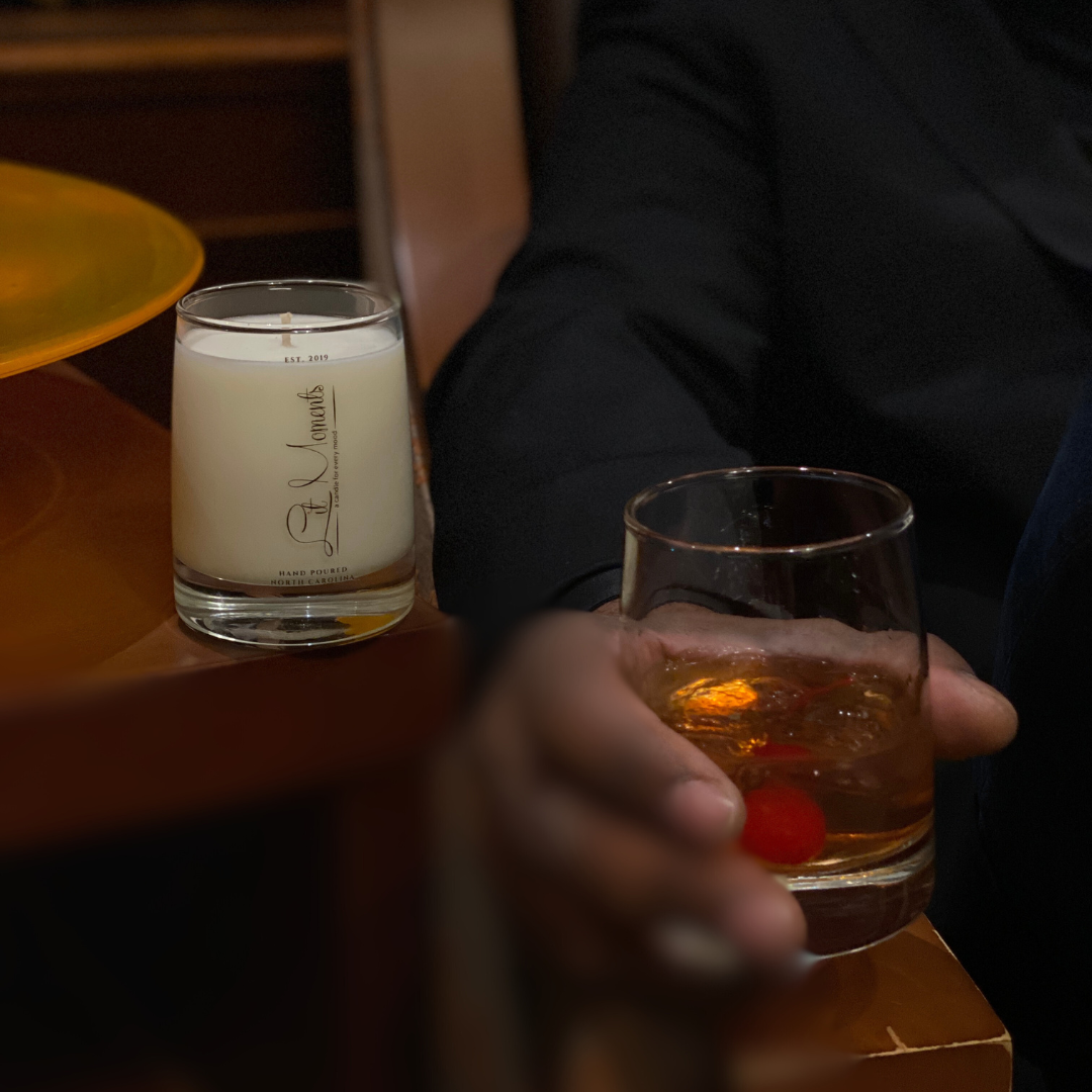 A hand-poured luxury candle from Lit Moments Candle Company, displayed in a sleek glass jar with a minimalist label, designed to elevate home decor.