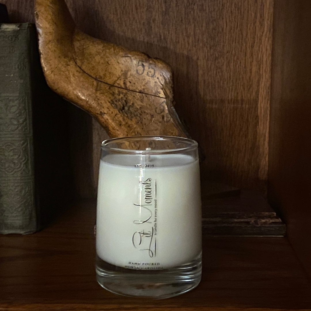 A hand-poured luxury candle from Lit Moments Candle Company, displayed in a sleek glass jar with a minimalist label, designed to elevate home decor.