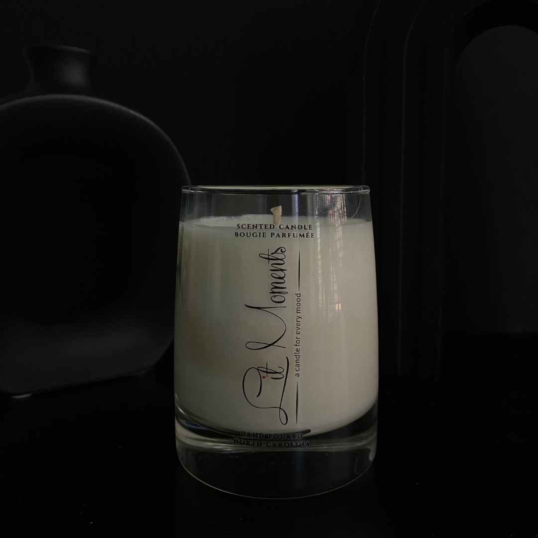 A hand-poured luxury candle from Lit Moments Candle Company, displayed in a sleek glass jar with a minimalist label, designed to elevate home decor.