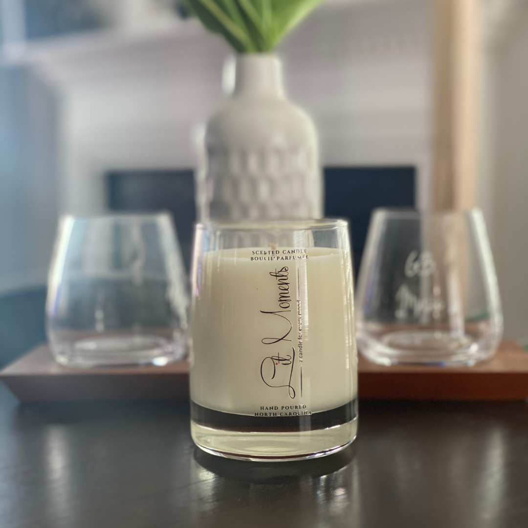 A hand-poured luxury candle from Lit Moments Candle Company, displayed in a sleek glass jar with a minimalist label, designed to elevate home decor.