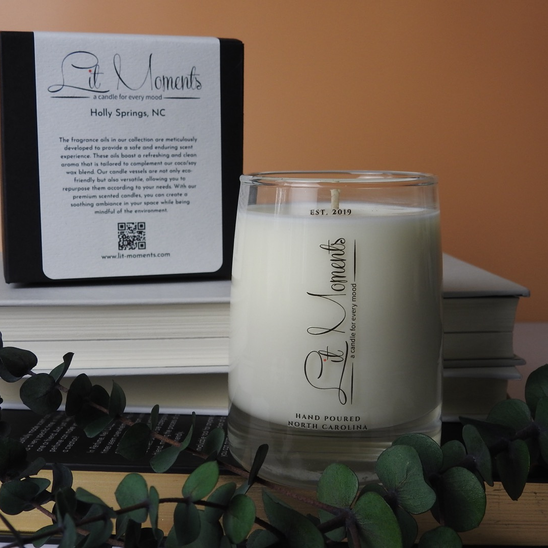 A hand-poured luxury candle from Lit Moments Candle Company, displayed in a sleek glass jar with a minimalist label, designed to elevate home decor.