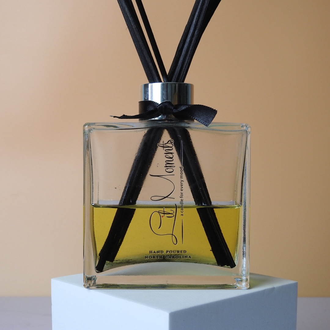 A Lit Moments Candle Company reed diffuser, with stylish reeds and a glass bottle, offering a continuous and subtle fragrance for your home.