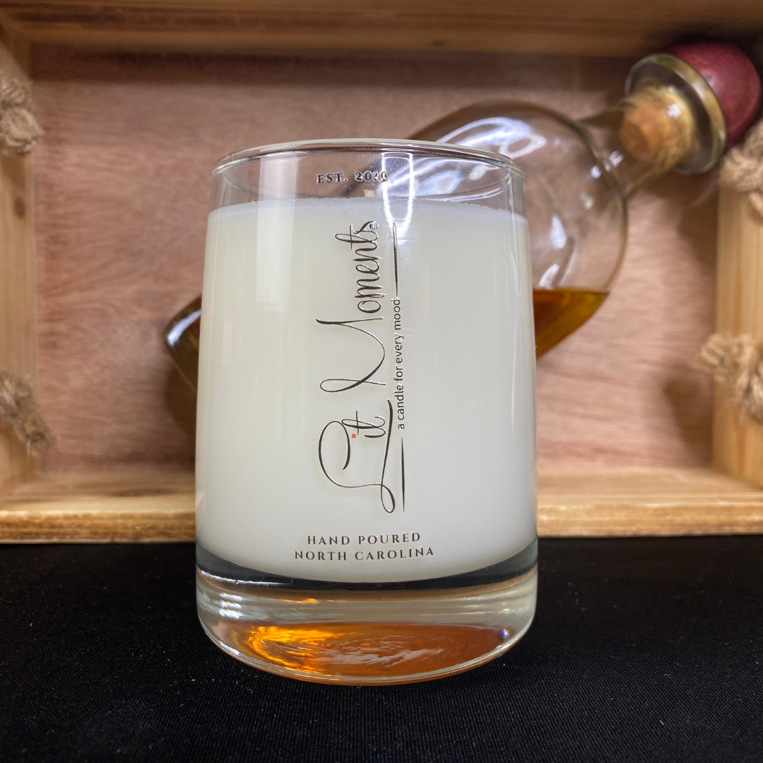 A hand-poured luxury candle from Lit Moments Candle Company, displayed in a sleek glass jar with a minimalist label, designed to elevate home decor.