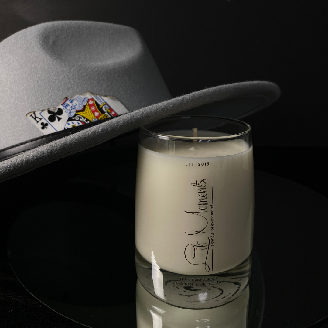 A hand-poured luxury candle from Lit Moments Candle Company, displayed in a sleek glass jar with a minimalist label, designed to elevate home decor.